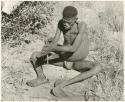 "Firemaking": Man twirling firesticks (print is a cropped image)