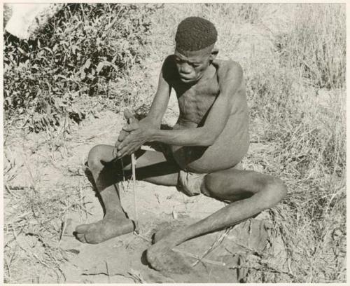 "Firemaking": Man twirling firesticks (print is a cropped image)