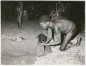 "Night dance at Tsumkwe 1957-8, some published in my [Lorna Marshall's] dance paper": Medicine man curing a sick person, with a circle of people dancing in the background (print is a cropped image)