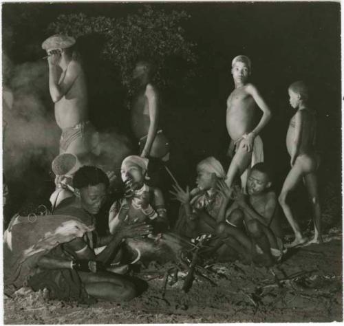 "Night dance at Tsumkwe 1957-8, some published in my [Lorna Marshall's] dance paper": Women assembling and starting a fire early in the dance (print is a cropped image)