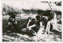 "Night dance at Tsumkwe 1957-8, some published in my [Lorna Marshall's] dance paper": /Gunda curing people, sitting with "Short /Qui" (print is a cropped image)