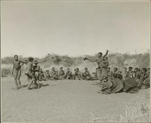 "Daytime dance at Gautscha": Two women and boys dancing, with a group of women sitting and clapping at the beginning of a dance (print is a cropped image)