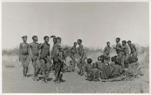 "Daytime dance at Gautscha": "Old /Gam" dancing and a medicine man (right) holding the arms of another who is in trance and leading him (print is a cropped image)