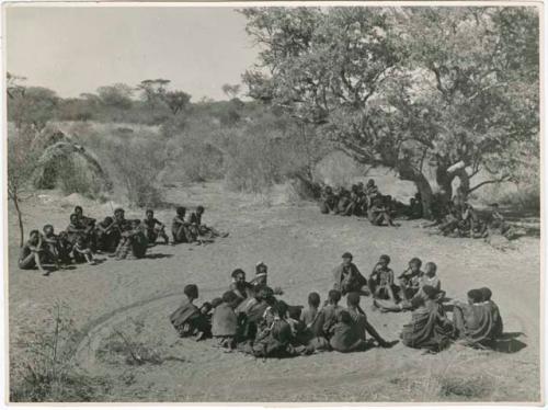 "Daytime dance at Gautscha": Men sitting and resting during an interval between dances (print is a cropped image)