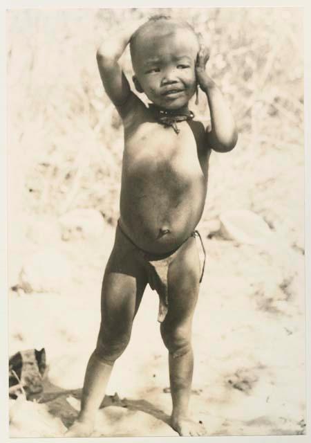 N!whakwe, full figure standing



