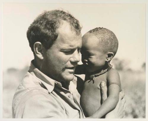 William Donnellan holding N!whakwe in his arms


