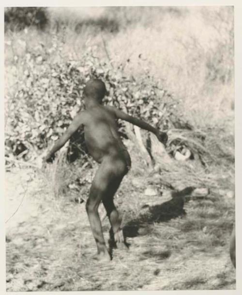 Boy dancing, seen from behind

