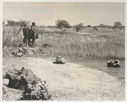 Casper Kruger and another expedition member standing and looking at the water




