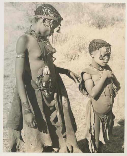 N!aba and another woman standing, wearing ornaments



