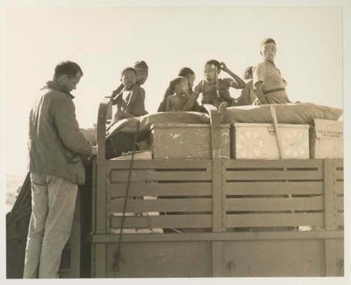 Group of people standing on top of the expedition truck with William Donnellan next to them


