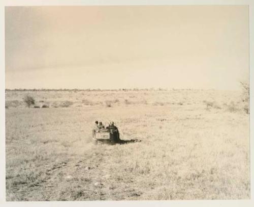 Group of people riding in the expedition Jeep with Wilhelm Camm and John Marshall


