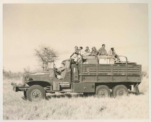 Group of people riding in the expedition GMC truck with William Donnellan driving


