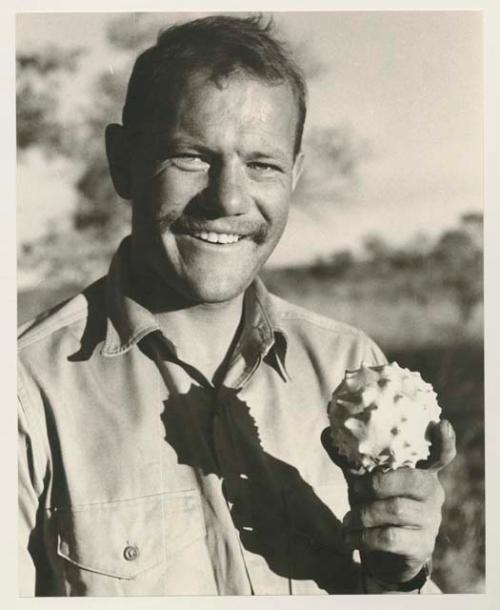 William Donnellan holding a cucumber

