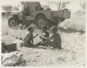 "Little ≠Gao" and ≠Toma's sons, Tsamgao and /Gaishay, all laughing with Jeep in the background