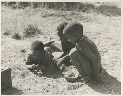 "Little ≠Gao," Tsamgao, and /Gaishay with Tsamgao's handmade toy gun
