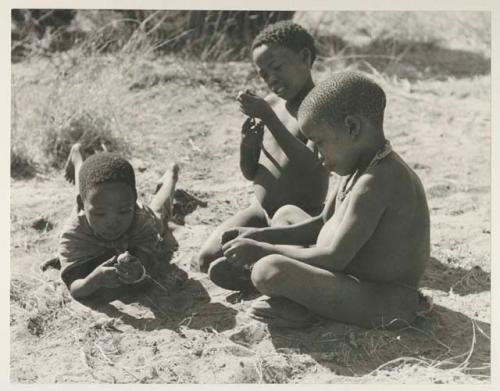 "Little ≠Gao," Tsamgao, and /Gaishay with Tsamgao's handmade toy gun
