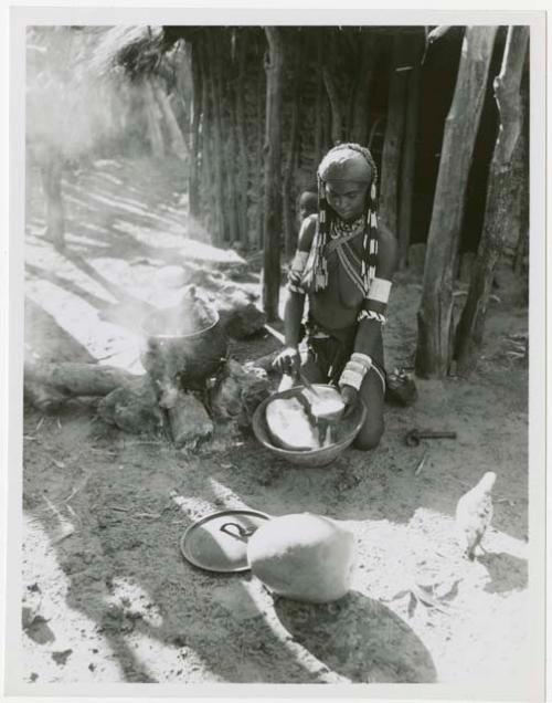 Rungiero preparing squash for cooking (print is a cropped image)