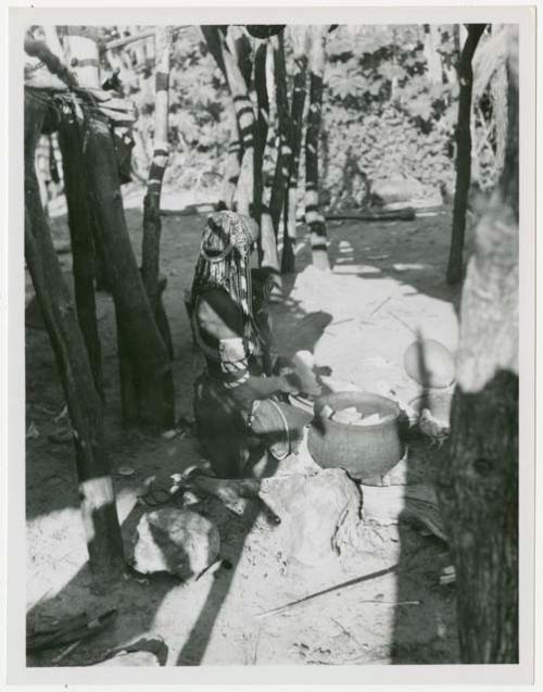 Rungiero preparing squash for cooking (print is a cropped image)