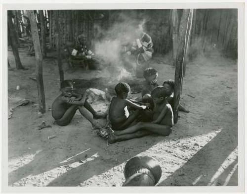 Children in Muremi's kraal with Makiena and other unidentified people in the background (print is a cropped image)