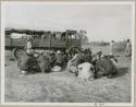 Groups from the WNLA (Witwatersrand Native Labor Association) convoy eating (print is a cropped image)