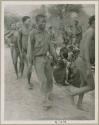 Curing dance for a sick baby at Moremi’s farm; men dancing behind the women, right to left: "/Qui Navel", /Ti!kay wearing western clothing, //Ao, and Tsamgao (/Ti!kay's son-in-law) (print is a cropped image)