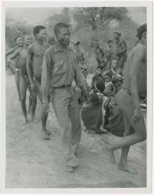 Curing dance for a sick baby at Moremi’s farm; men dancing behind the women, right to left: "/Qui Navel", /Ti!kay wearing western clothing, //Ao, and Tsamgao (/Ti!kay's son-in-law) (print is a cropped image)