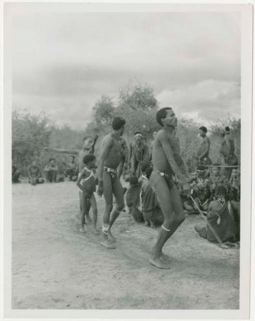 Curing dance for a sick baby at Moremi’s farm; men dancing behind the women (print is a cropped image)