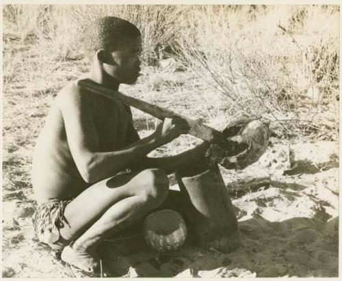 !Gai scraping turtle meat into a mortar with a fire paddle