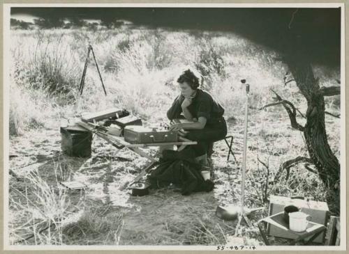 Elizabeth Marshall Thomas sitting with recording equipment  (print is a cropped image)