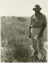 Robert Story standing beside a plant