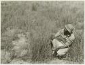 Robert Story sitting beside a plant