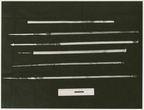 Six arrows on a black background with a ruler for measurement (print is a cropped image)