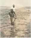 Casper Kruger and Elizabeth Marshall Thomas wading in Lake Ngami




