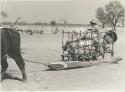 Sled loaded with sacks, with a man riding in it












