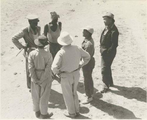 Group of people including Laurence Marshall, Kernel Ledimo, William Donnellan, and Herero people, seen from top of truck








