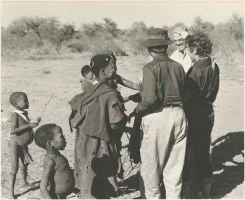 Expedition members, including, Laurence Marshall, Lorna Marshall, and Elizabeth Marshall Thomas, greeted by a group of Ju/'hoansi


