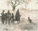 "Little ≠Gao" holding a stick and a group of unidentified Ju/'hoan women and children















