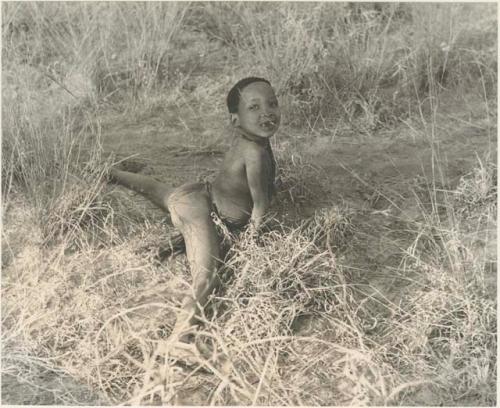 "Little ≠Gao" lying on the ground, his legs spread apart


















