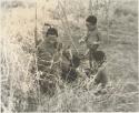 "/Qui Navel" seated with unidentified boys beside him





















