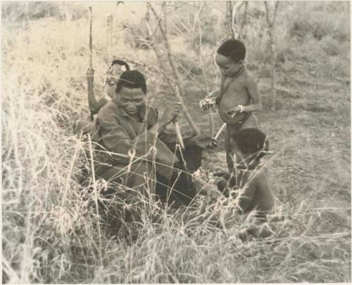 "/Qui Navel" seated with unidentified boys beside him





















