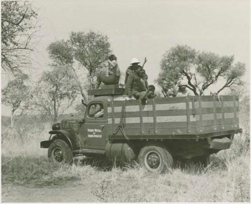 Power wagon with Elizabeth Marshall Thomas on top and a group of Ju/'hoansi and expedition members in the back
































