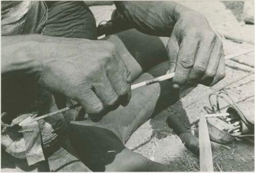 Person's hands fitting shaft to connecting link






























