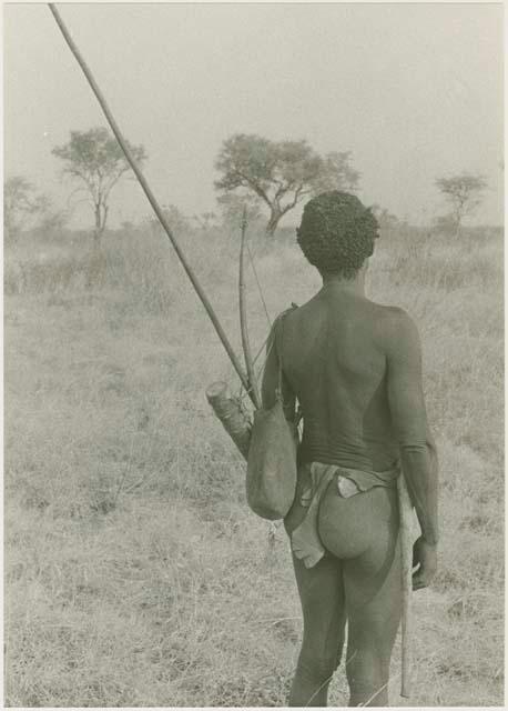 "Old Gau" with a quiver, bow, and spear hanging over his left shoulder, seen from behind








































