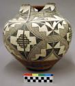 Pottery olla. Globular, red ware, white with black design. 11.5" (height).