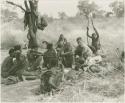 Group of people including "/Qui Hunter" lying down, ≠Toma, John Marshall, and !Kham holding sticks as crutches

















































