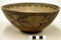 Pottery bowl. Flat base, red ware, thin greyish tan slip. Black scalloped bord