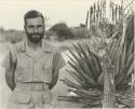 Daniel Blitz with a beard, standing by aloe plant

