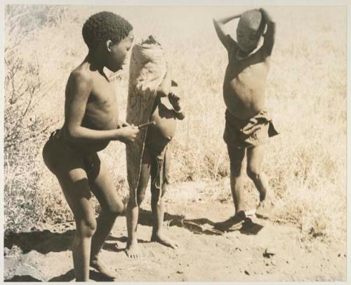 Tsamgao, "Little ≠Gao," and /Gaishay (!U and ≠Toma's son), dancing
