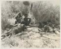 Group lying in the shade mostly likely eating meat including "Old Gau", Tsamgao, "Little ≠Gao", /Gaishay (!U and ≠Toma's son), and two unidentified people

