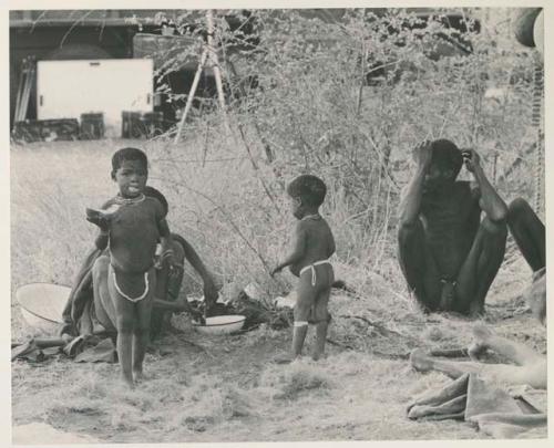 "Gao Medicine" and /Naoka (his first wife) along with their two children sitting in front of the expedition's truck



